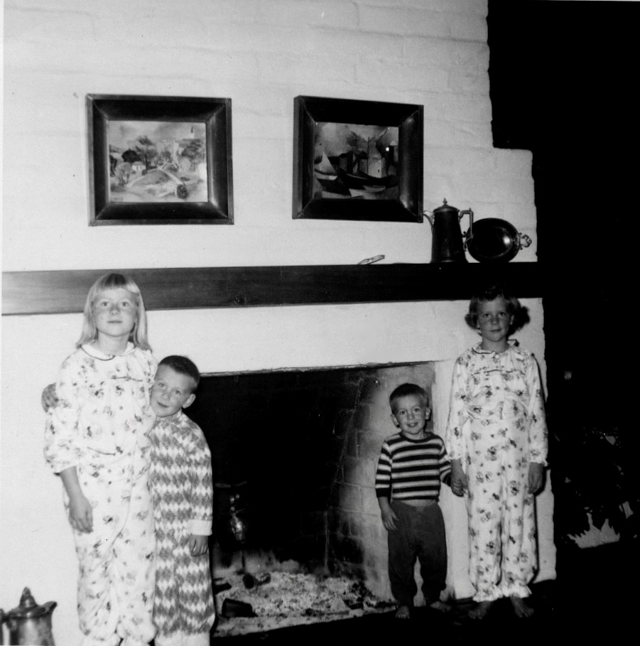 Porter children in front of fireplace